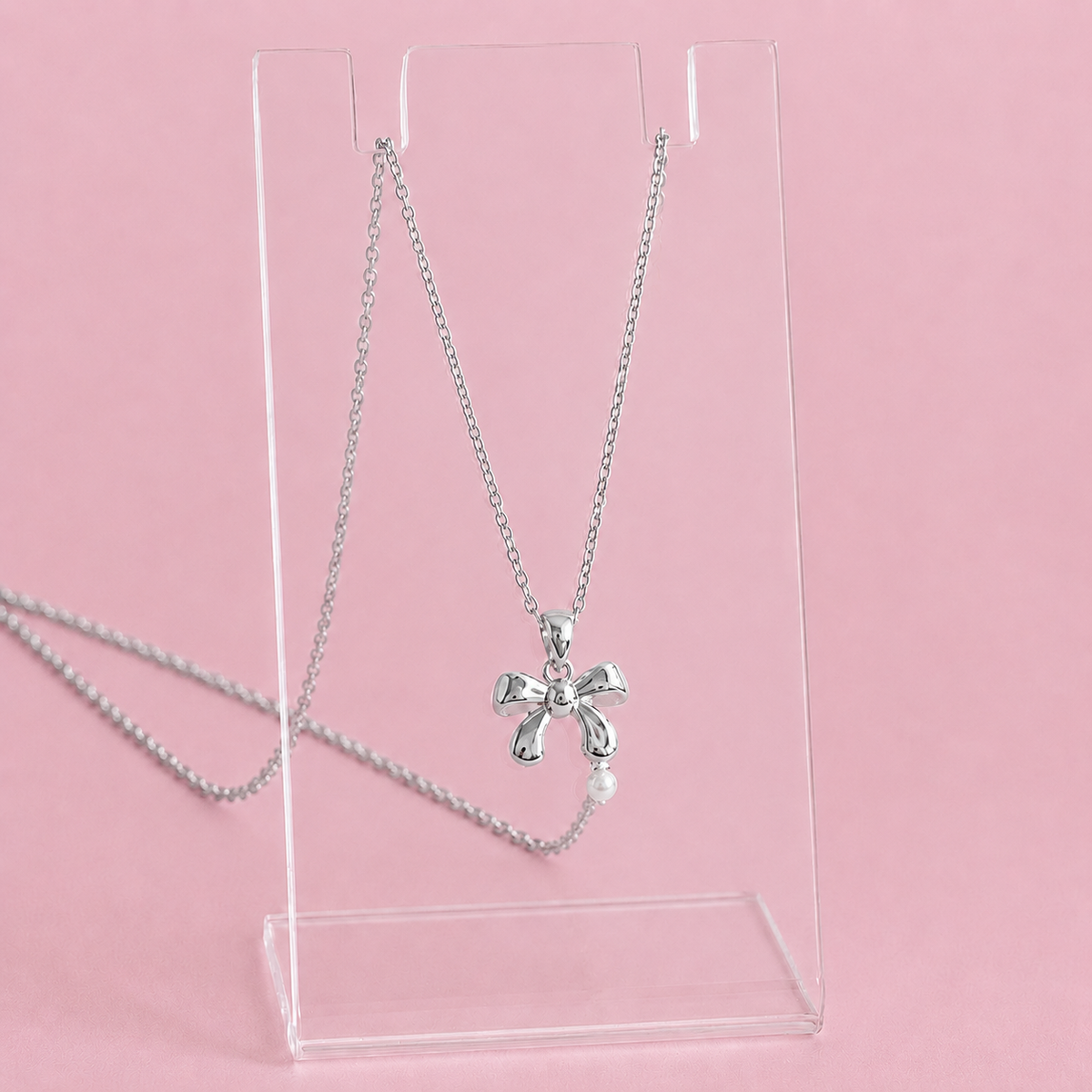 Silver necklace with a bow pendant