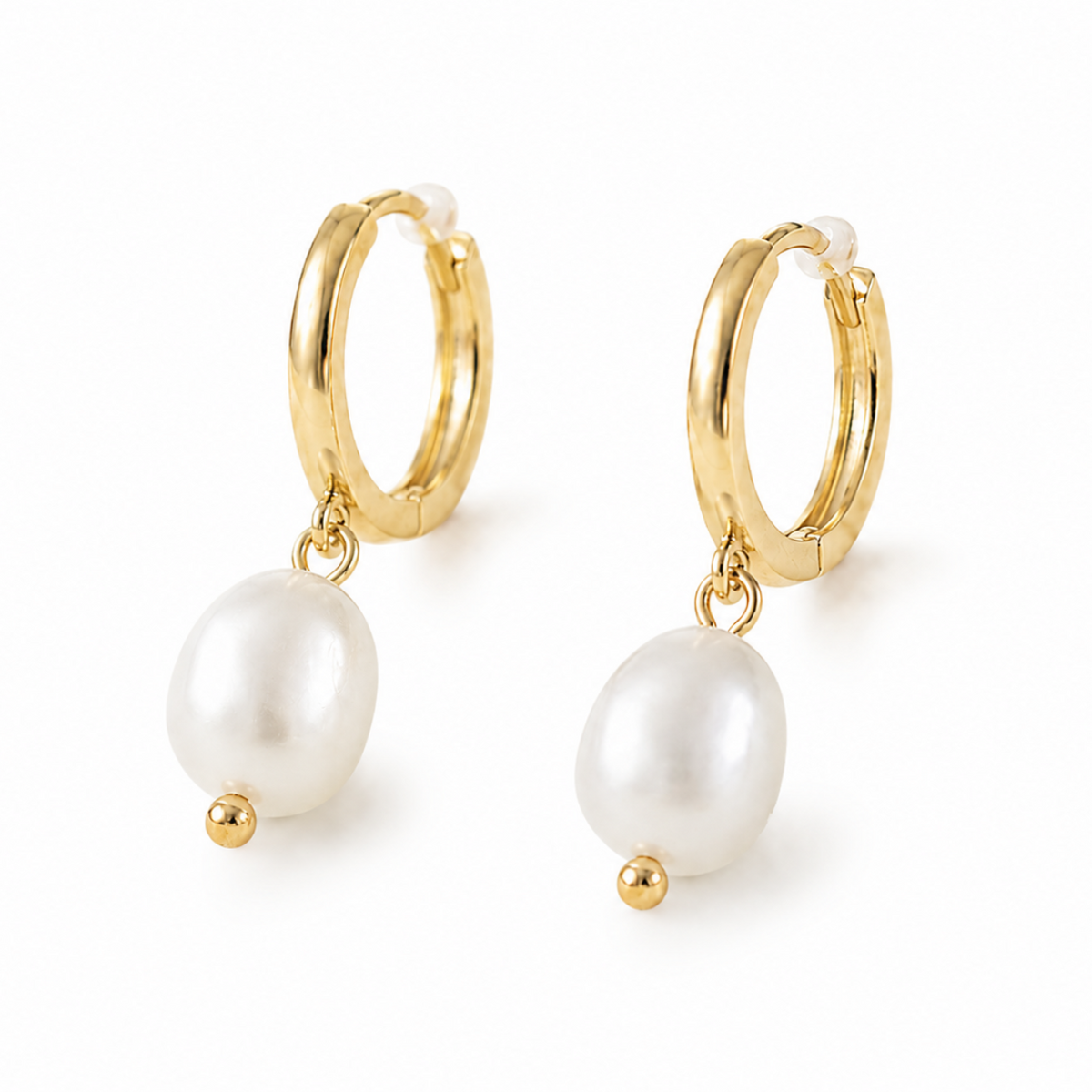 A pair of gold huggie hoop earrings with a dangling white freshwater pearl and a small gold bead accent, shown on a clean white background.