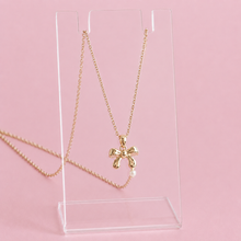 Load image into Gallery viewer, Gold necklace with a bow pendant
