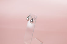 Load image into Gallery viewer, Silver earrings on a pink background

