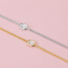 Load image into Gallery viewer, Two delicate chain bracelets, one in silver and one in yellow gold, each featuring a rectangular clear gemstone bezel setting, displayed diagonally on a solid pink background.
